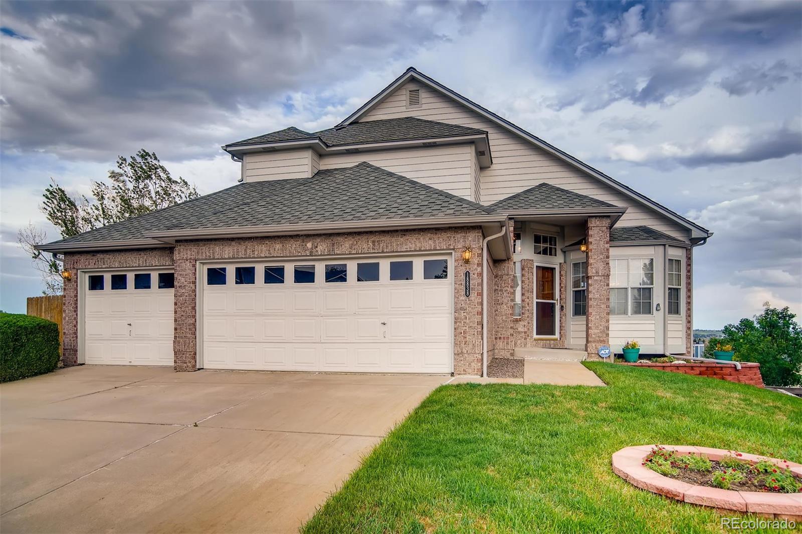 A house with two garage doors and a driveway.