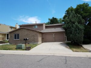 A house with two garage doors and a driveway.